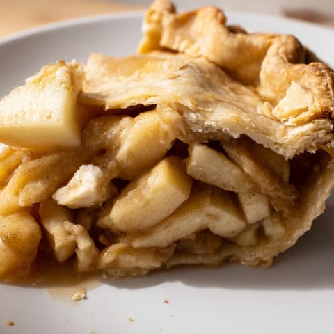 A close-up of a freshly baked Apple Pie, ready to be sliced and served warm.