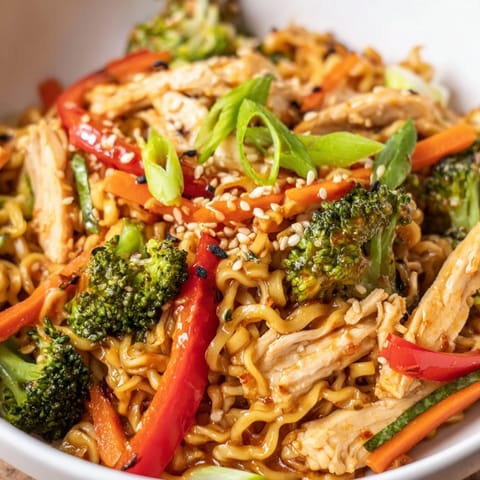 Sizzling Spicy Ramen Stir-Fry with tender chicken, crisp bell peppers, and broccoli tossed in a bold, garlicky sauce.