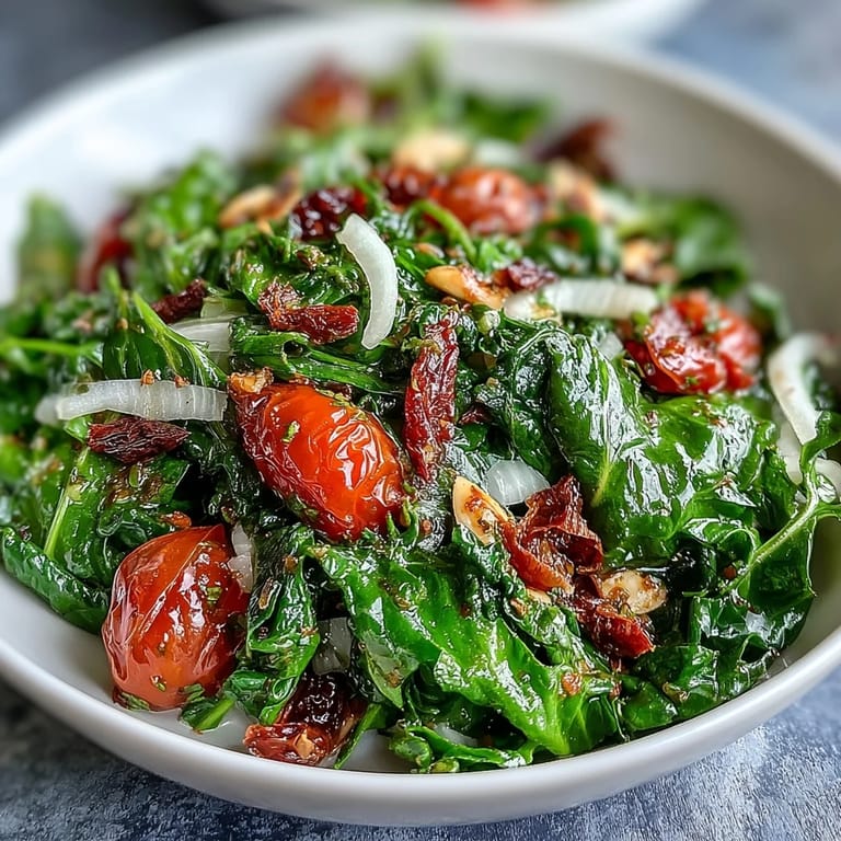 Fresh dandelion greens salad topped with shaved Parmesan, cherry tomatoes, and a bright lemon Dijon dressing.