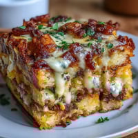 A golden, bubbling breakfast casserole loaded with sausage, eggs, and cheese, perfect for feeding a hungry crowd.